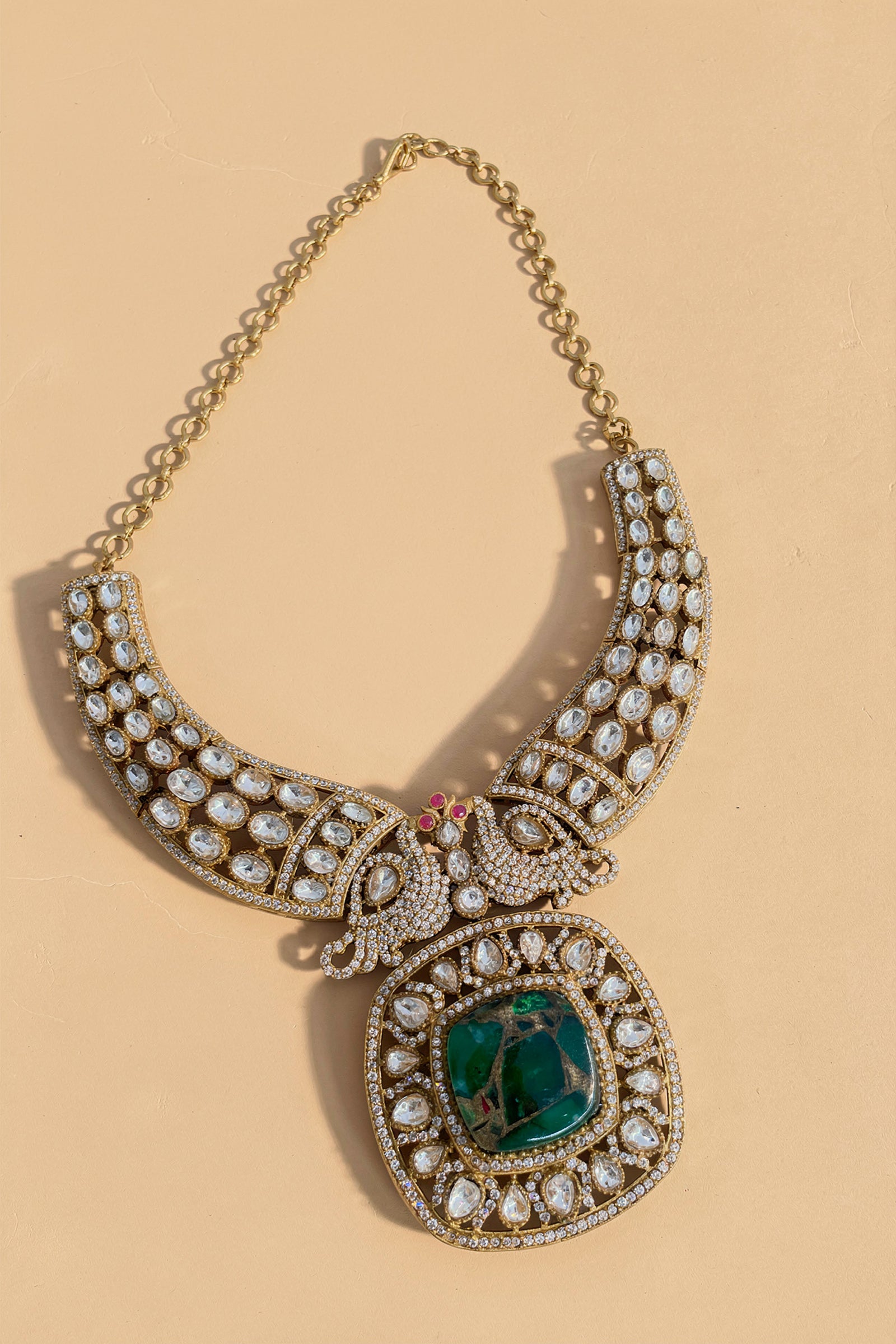 Gold Kundan-Style Green Stone Necklace Set with Intricate Filigree Detailing & Matching Earrings