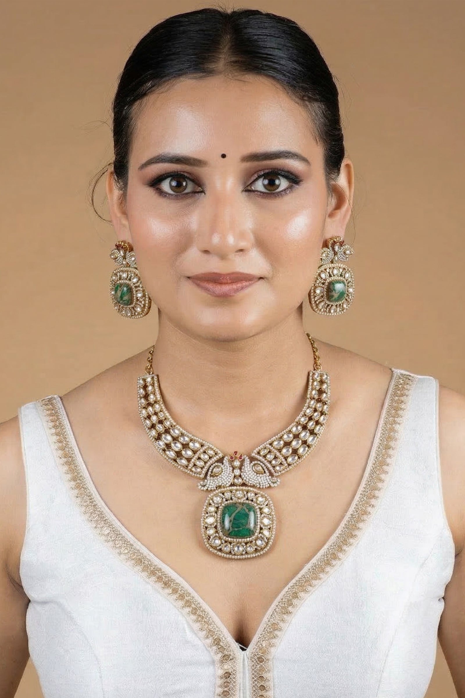 Gold Kundan-Style Green Stone Necklace Set with Intricate Filigree Detailing & Matching Earrings