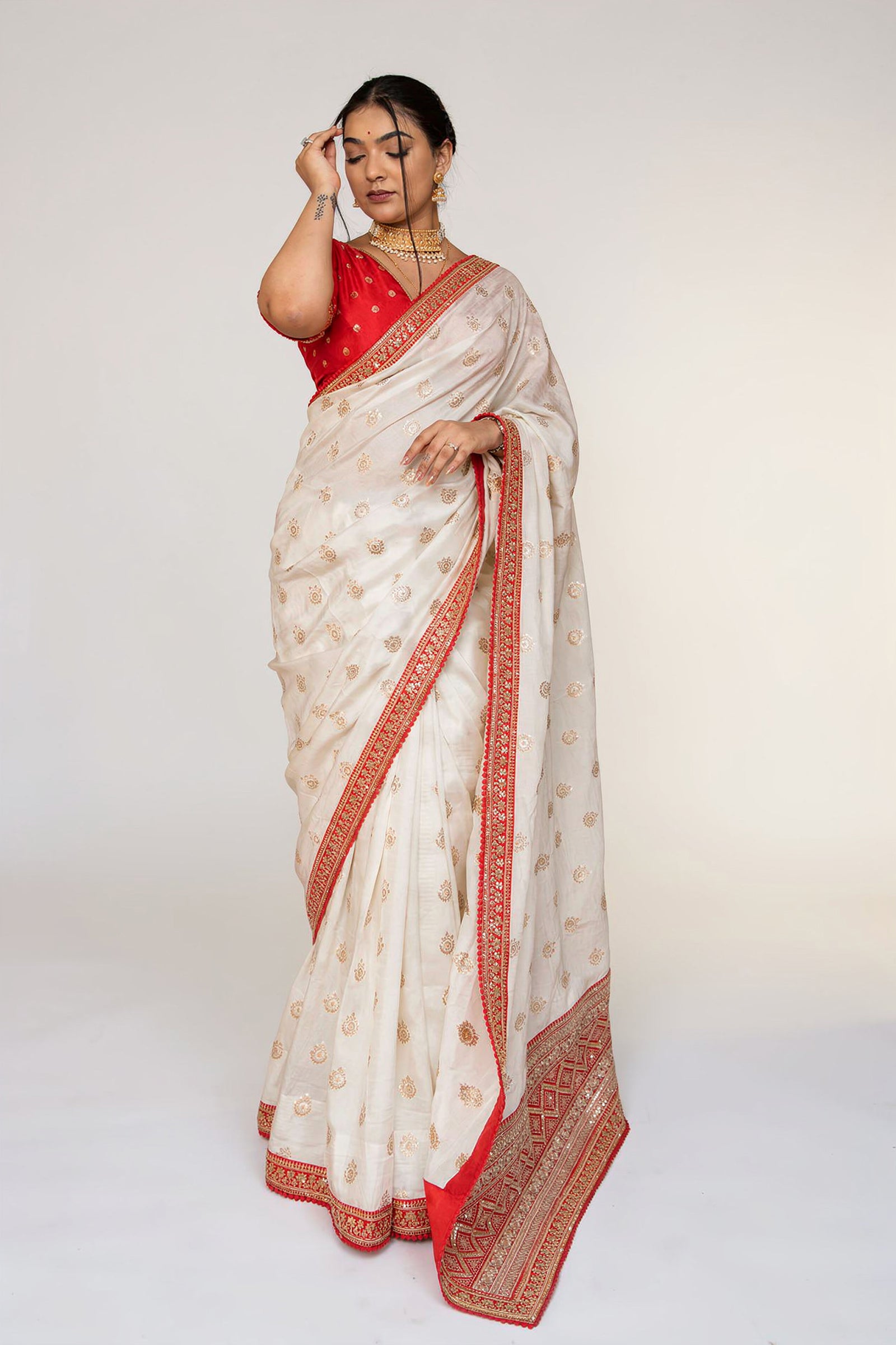 Cream Silk Saree with Golden Buti Work and Rich Red Zari Border